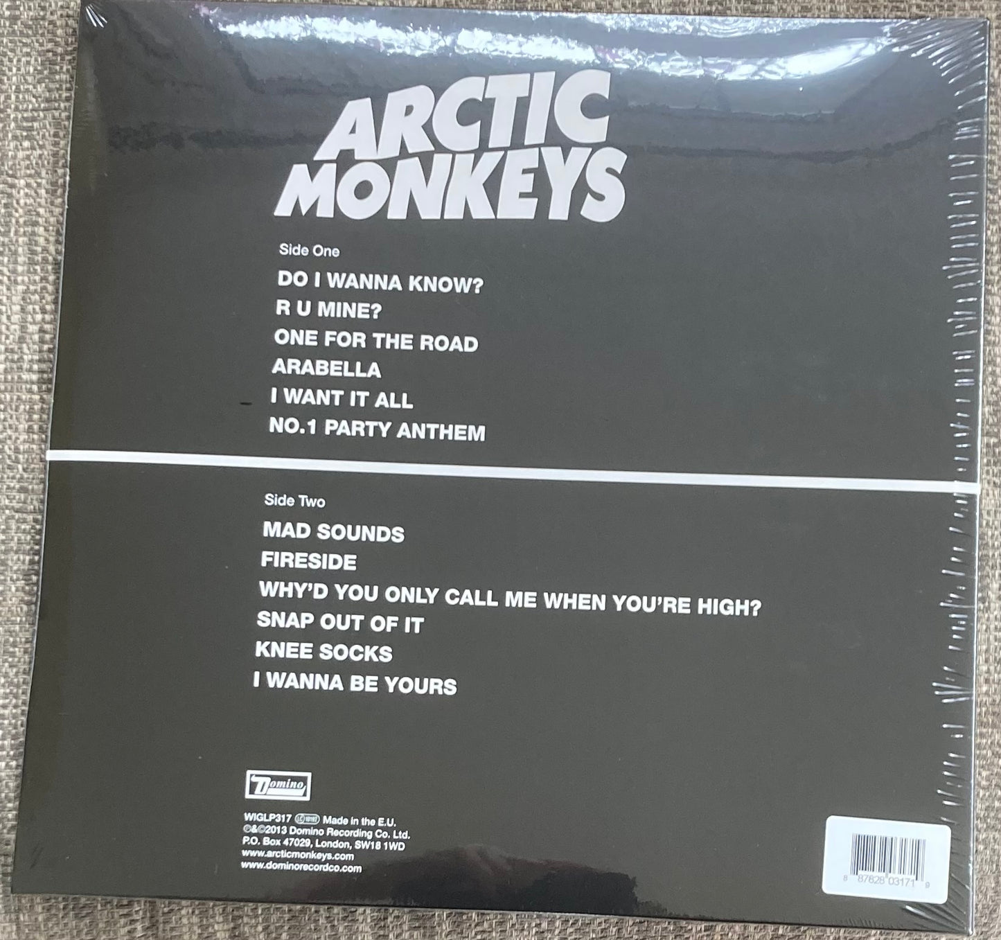The back of 'Arctic Monkeys - AM' on vinyl. It is brand new and sealed.
