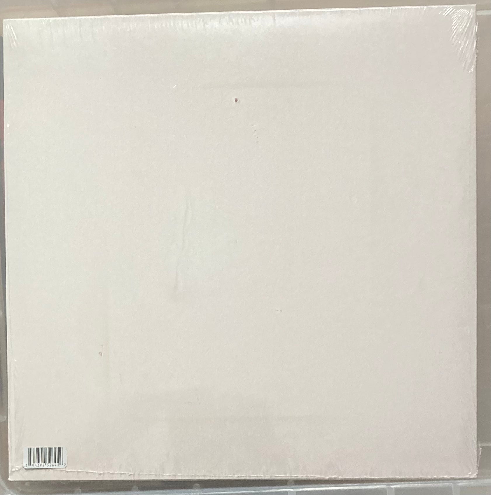 The back of 'Arcade Fire - Her' on vinyl