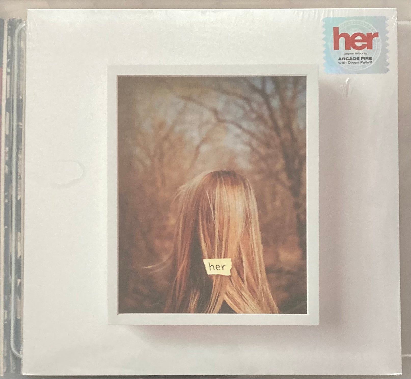 The front of 'Arcade Fire - Her' on vinyl