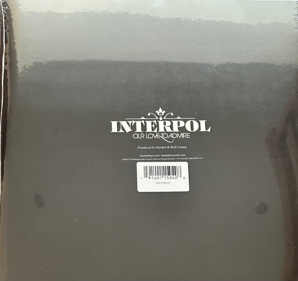 Limited edition blue vinyl LP record of Interpol 'Our Love to Admire'. The back of the sleeve has a black background with the band's logo.