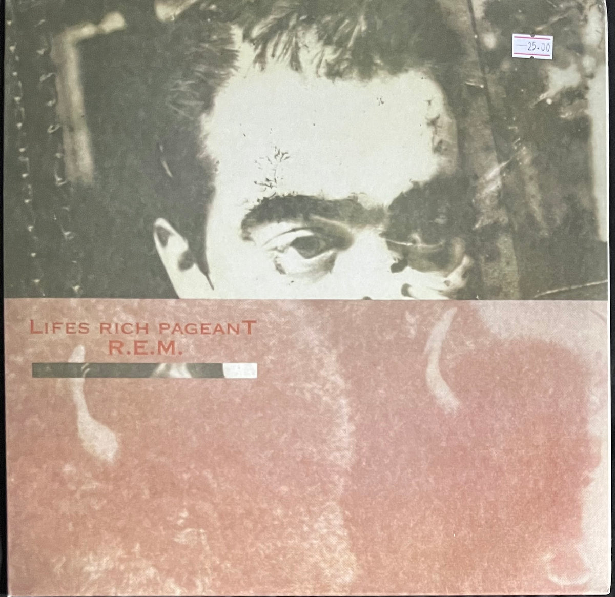 Vinyl record cover for R.E.M.'s 'Lifes Rich Pageant' with a close-up of a person's face.
