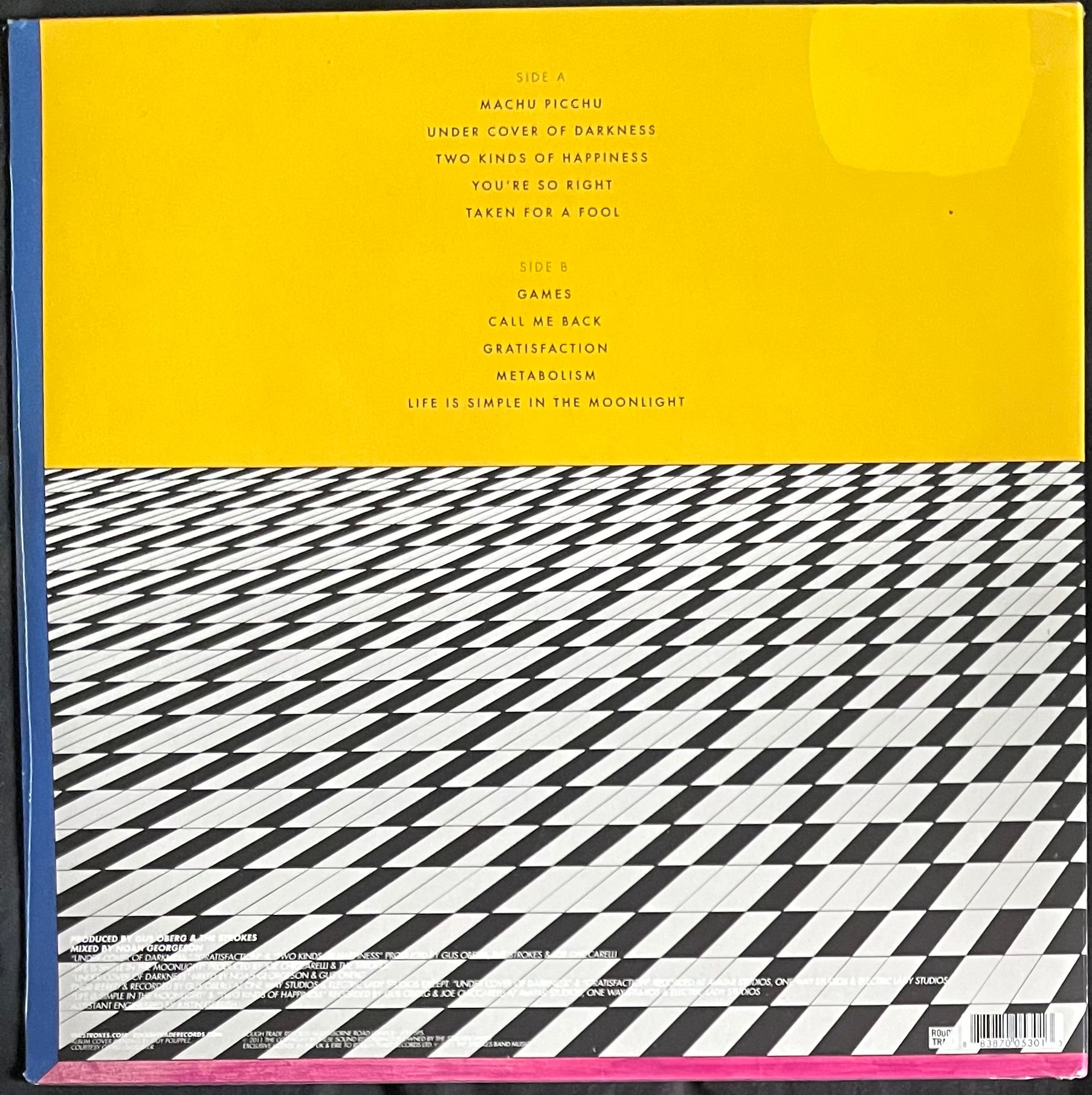 Vinyl record cover with yellow top section and black and white patterned bottom section